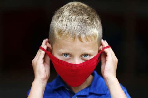 young boy in red mask